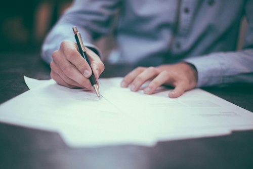 Business owner signing loan paperwork